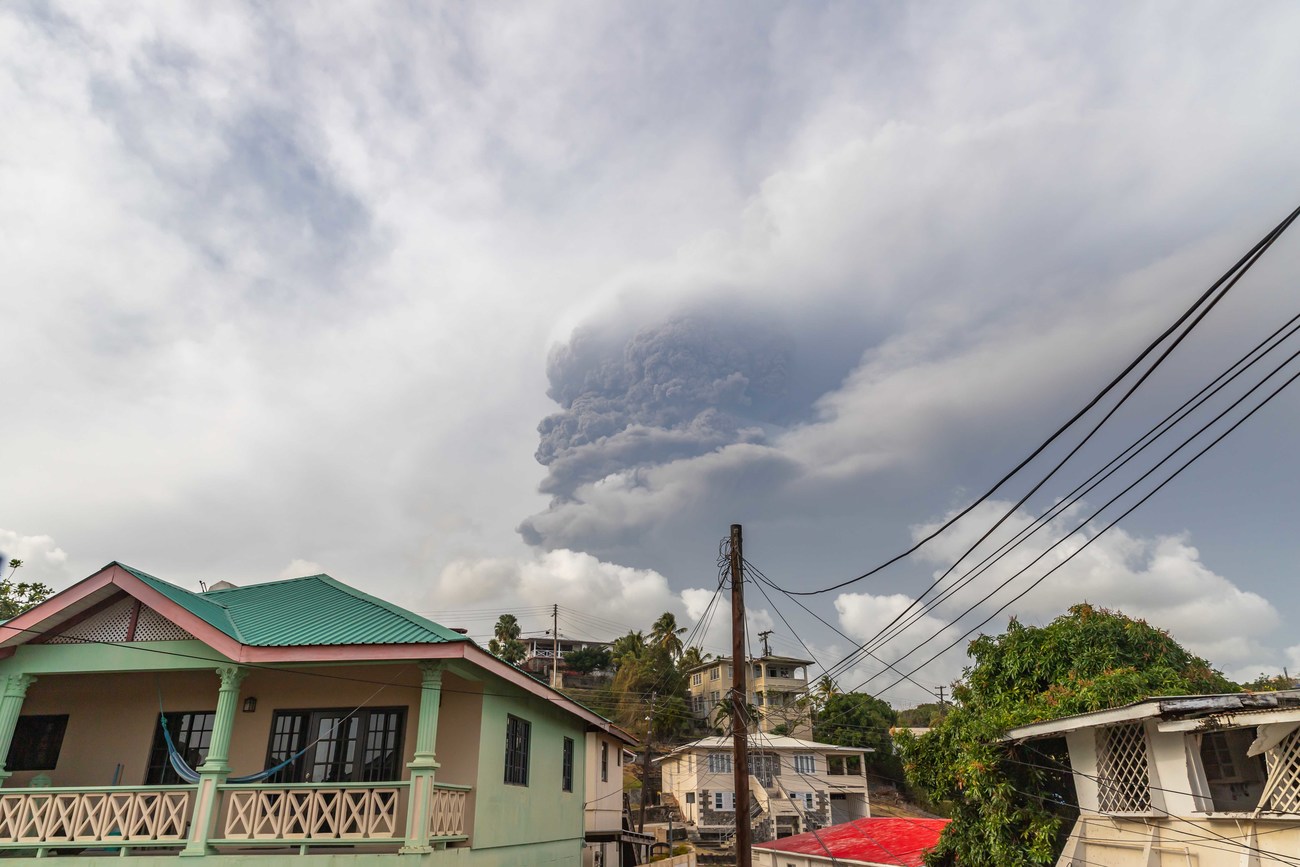 Smoke from volcanic eruption above a home in St. Vincent