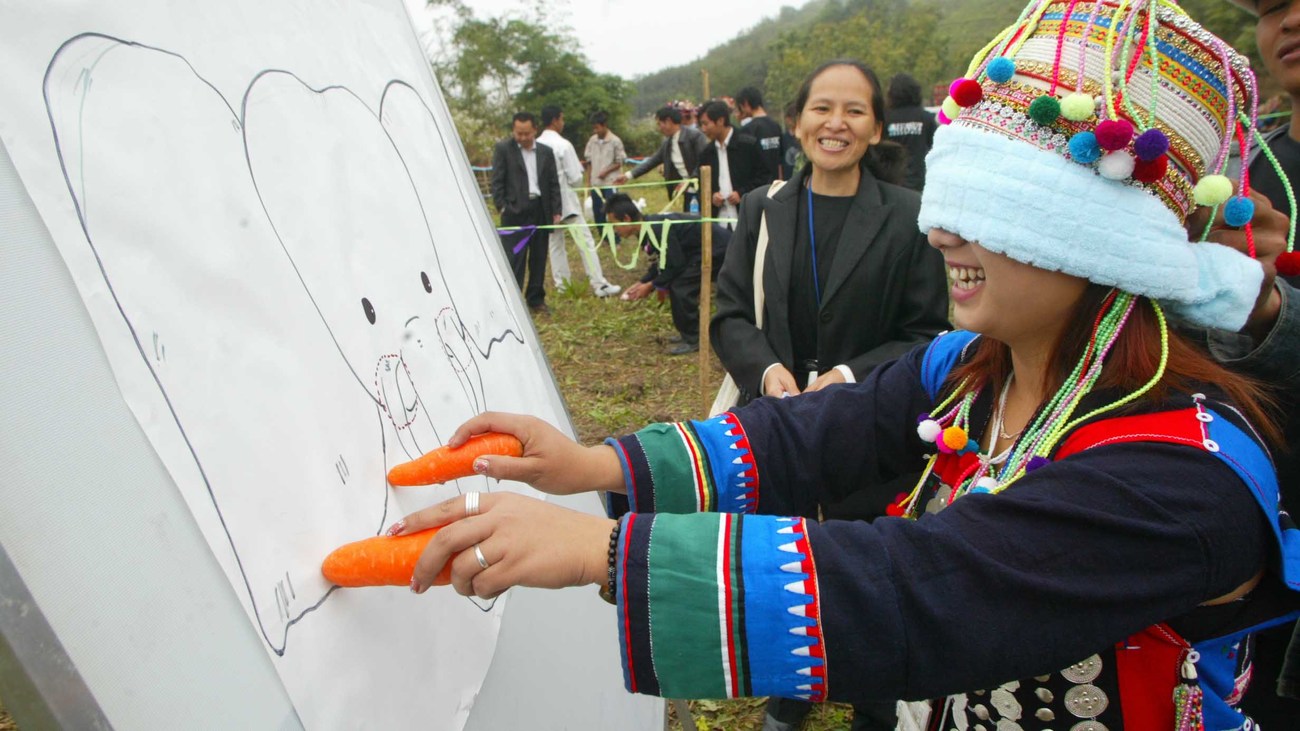 a girl smiles as she plays an elephant education game