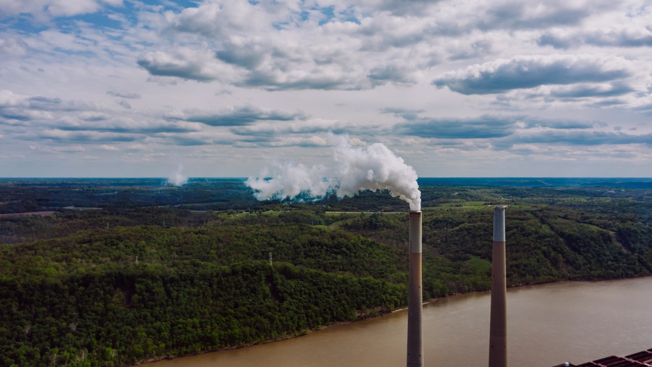 smoke stacks near a forest