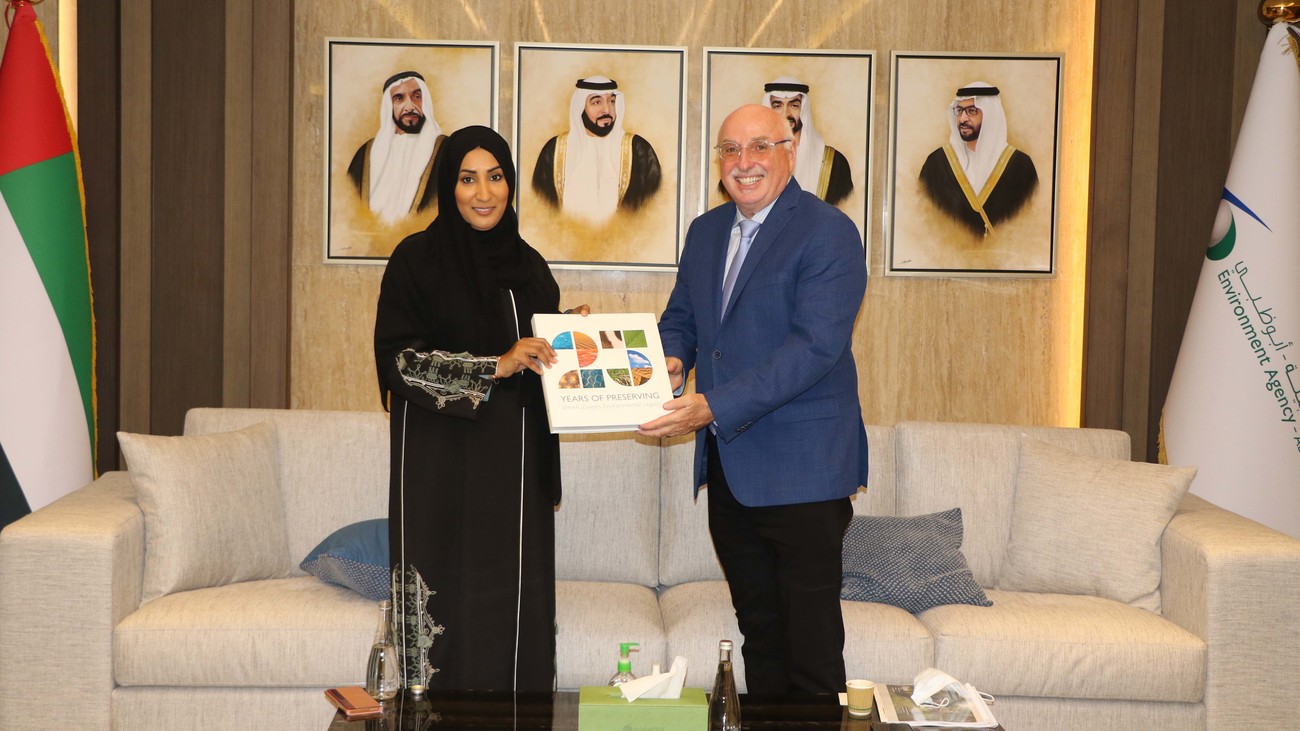 Dr. Daheri and Azzedine Downes hold a book