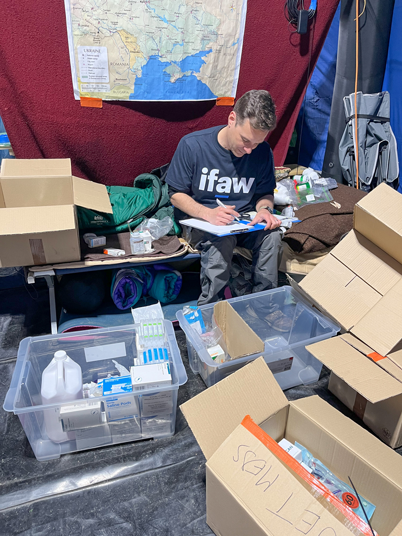 Veterinarian Paul Ramos works behind-the-scenes to keep donations in order at the blue animal service station tent at the Ukraine-Poland border crossing in Medyka, Poland.