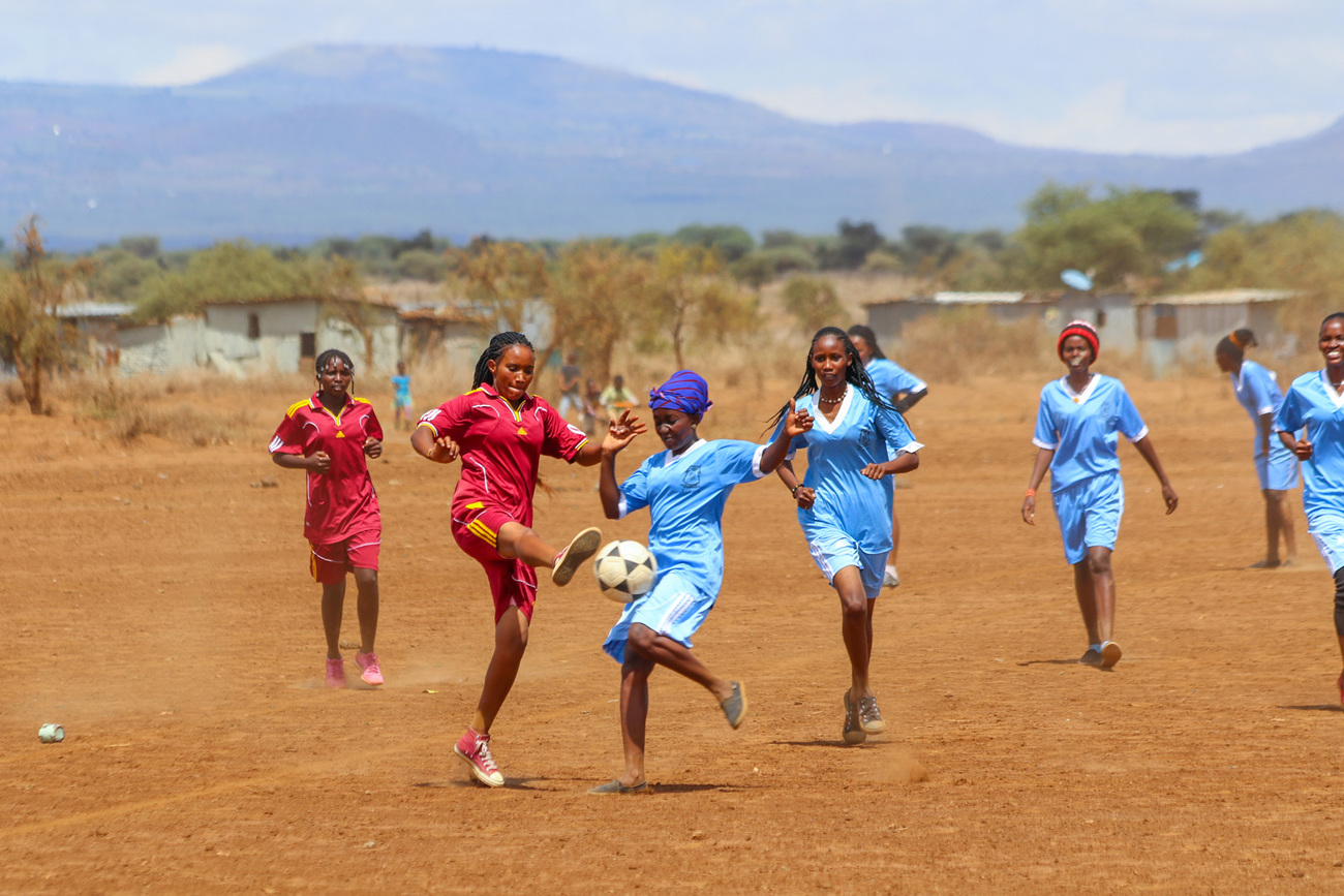 The Jenga Mama women playing soccer on sports and mentorship day.