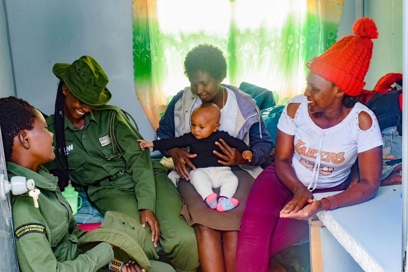 Team Lioness rangers including Alphine, right, with Alphine’s seven-month-old son Memeri at the ranger base.