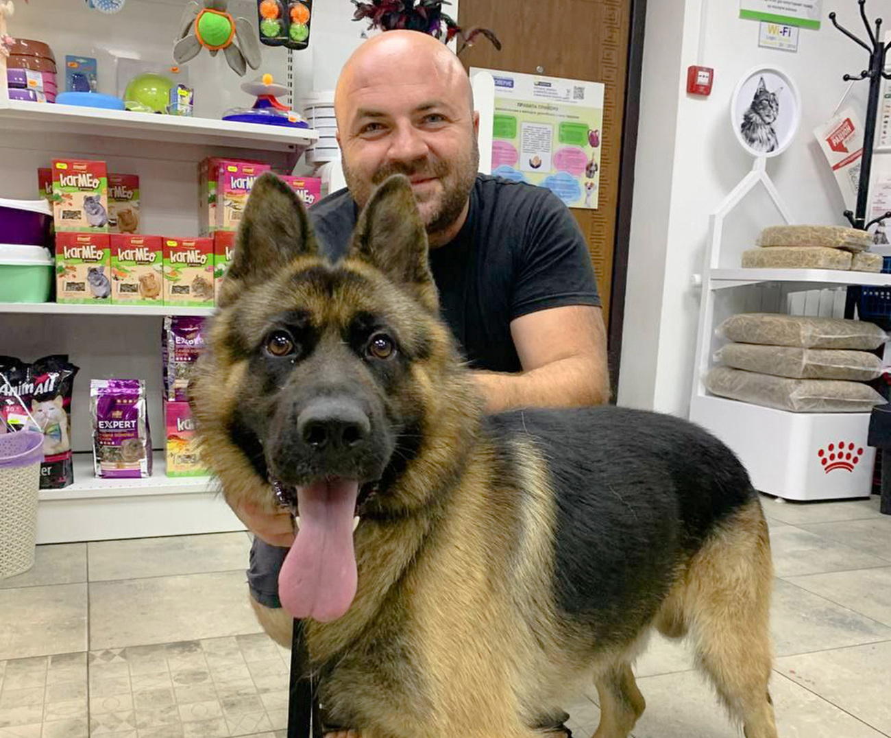 A man with his dog after being helped at a veterinary clinic.