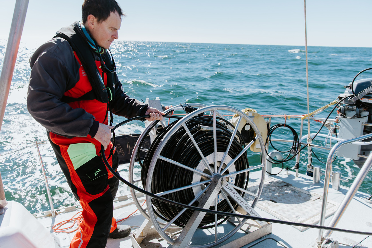 Chief scientist Dr. Oliver Boisseau prepares to deploy a hydrophone array to listen for cetacean vocalizations.