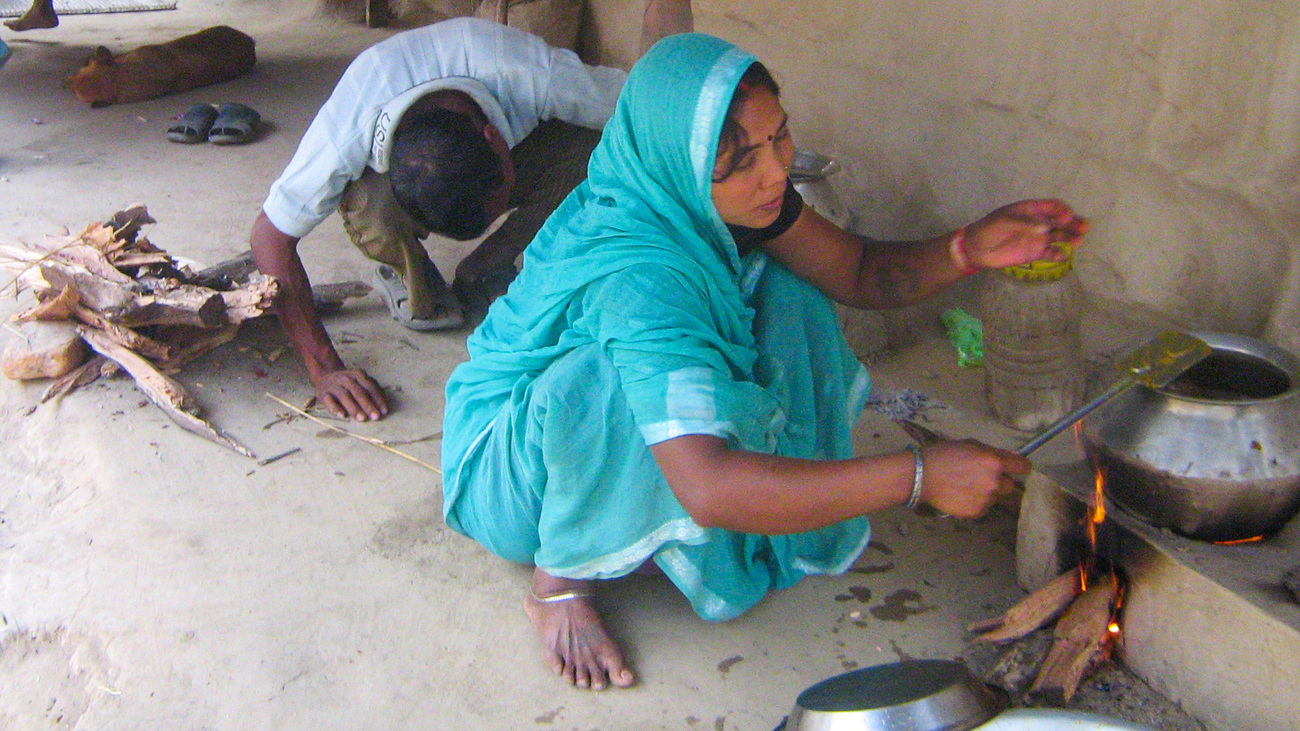 Women preparing food using the improved cookstove design.