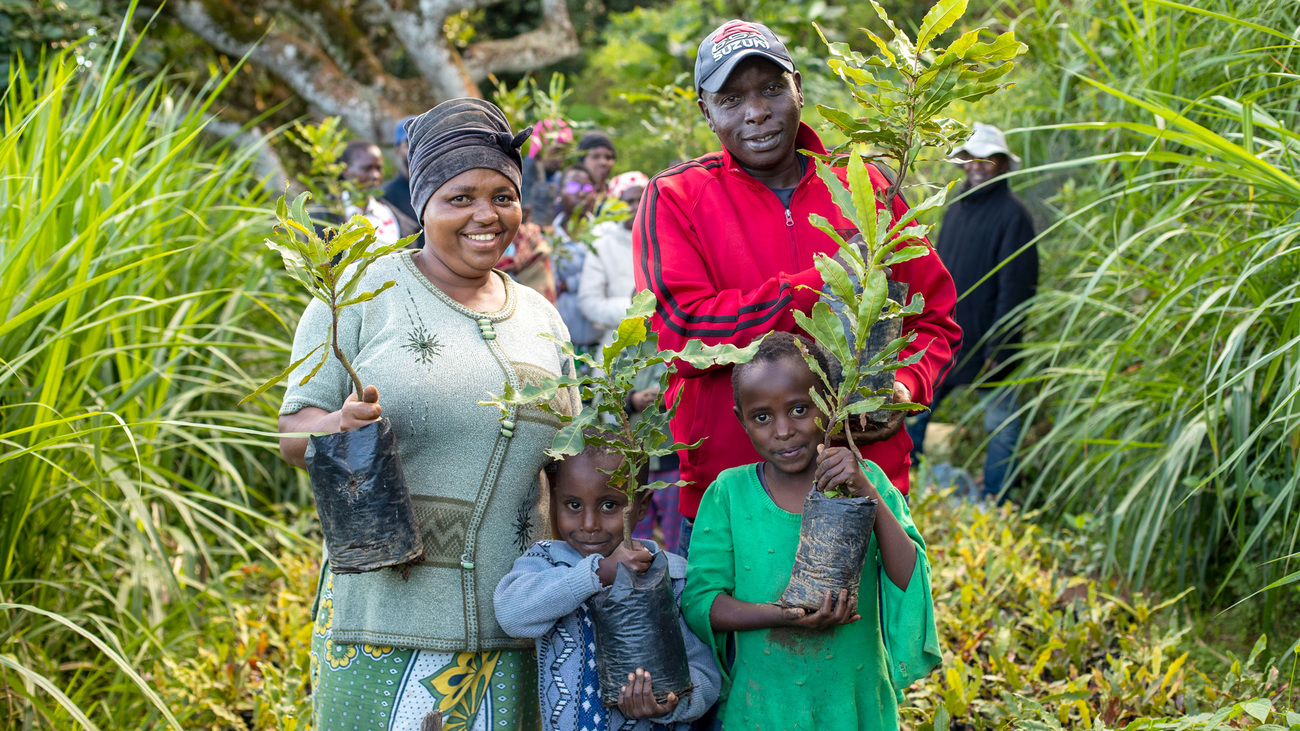 Latin Mwasi, macadamia farmer and nursery owner, with his family.