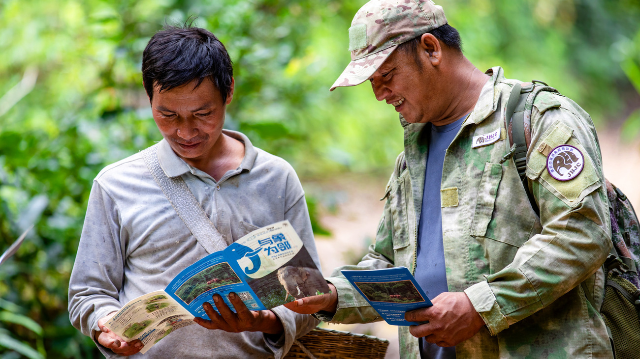 A community ranger shares a leaflet