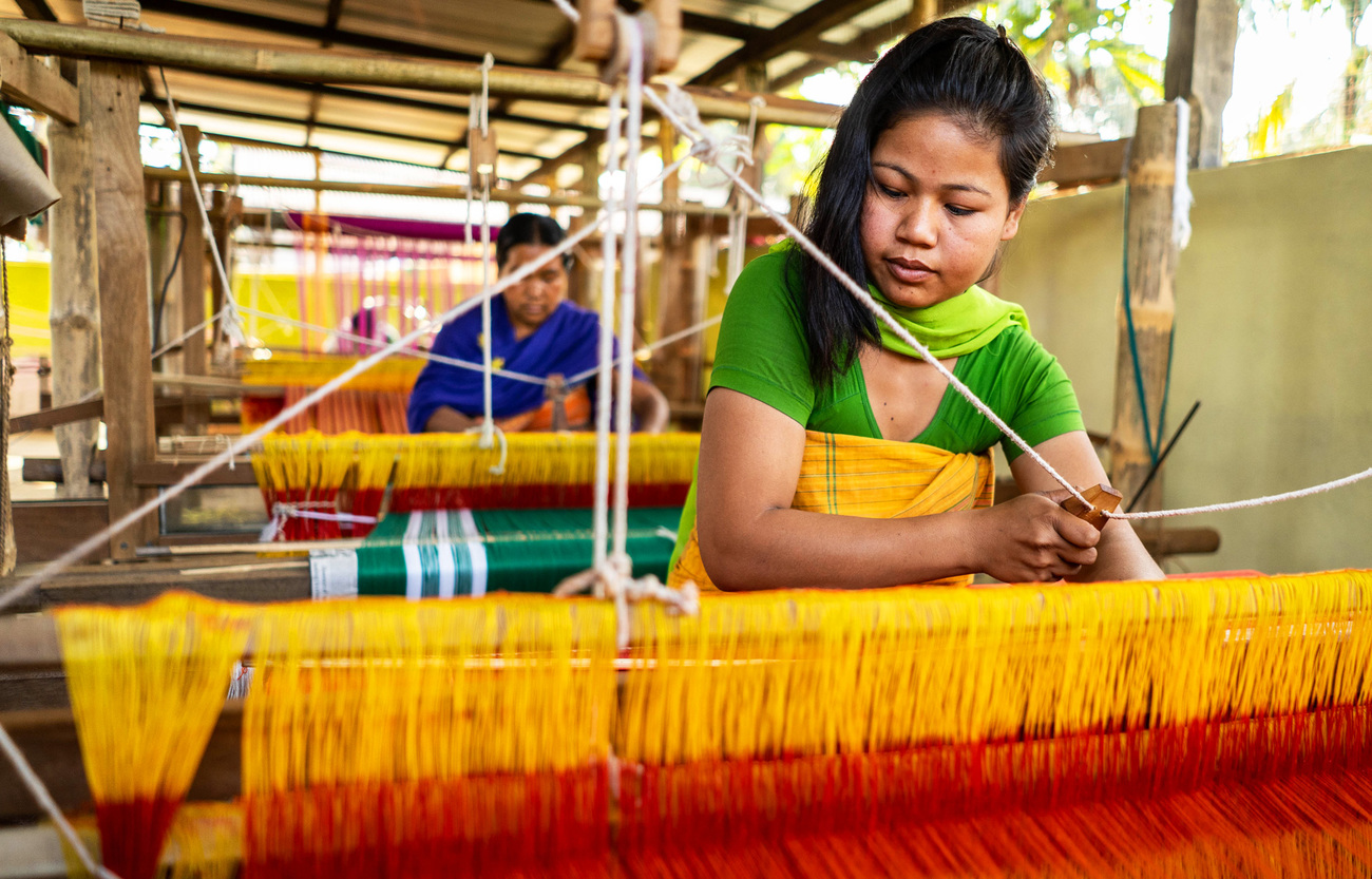 Sansumwi Basumatary uses a wooden loom to weave cloth at an IFAW-supported weaving center on the edge of Manas National Park, Assam, India.