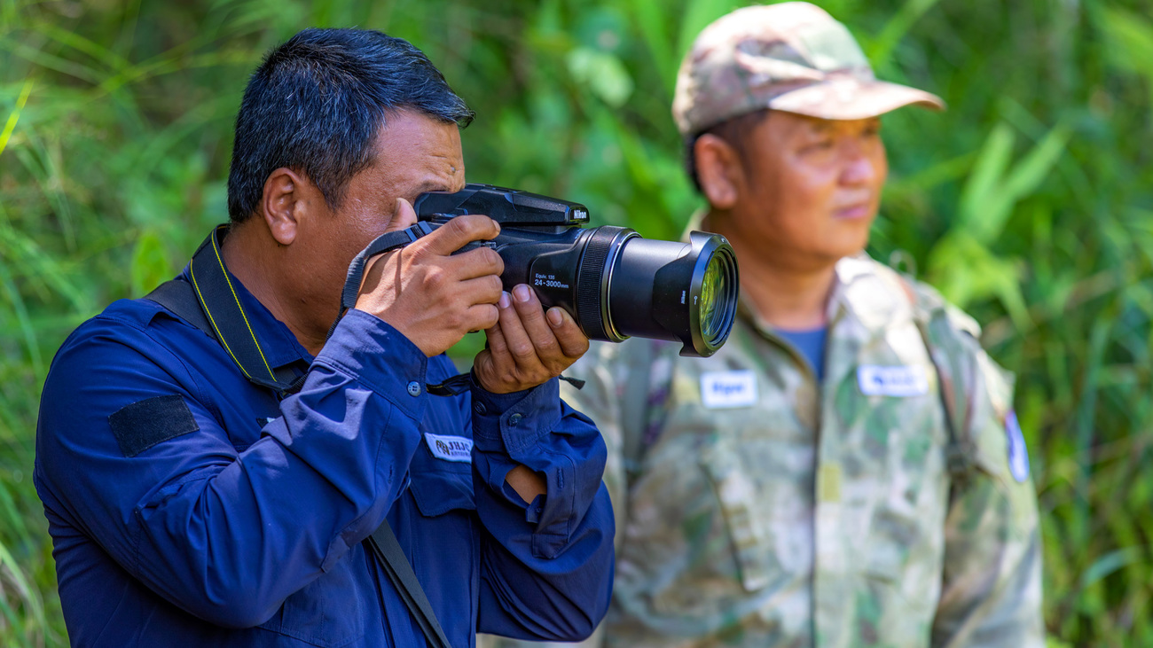 A community ranger in Yunnan Province completing one of his daily tasks—photographing signs of Asian elephant activity