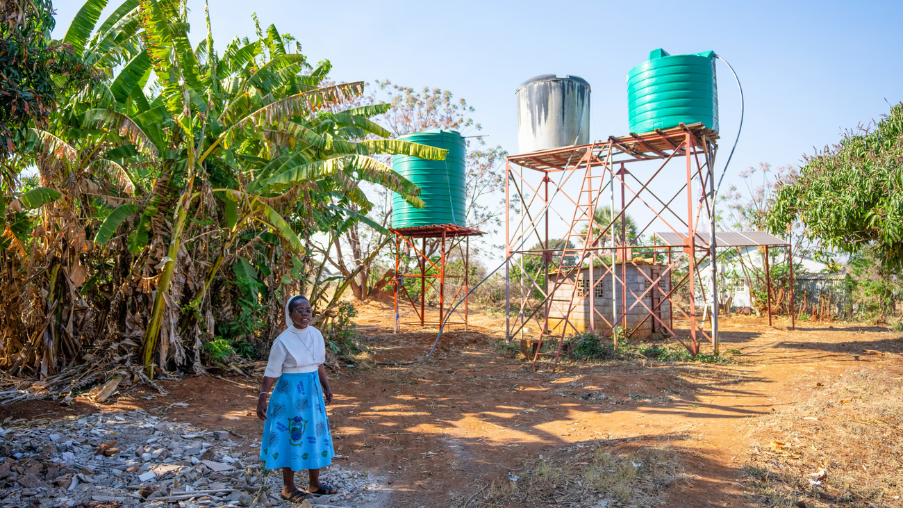 Sister Cecilia with new water tanks at Dete Old People’s home, one of many improvements resulting from the IFAW-ZimParks partnership.
