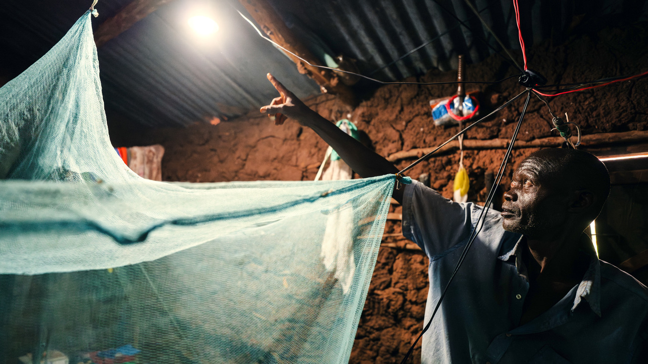 Christopher, a local farmer between Tsavo West and Tsavo East national parks who is part of the climate-smart agriculture project, with solar lights provided by IFAW and USAID.