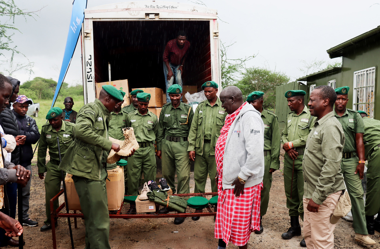 IFAW’s James Isiche and OOGR’s Daniel Leturesh handing over new uniforms for Olgulului Community Wildlife Rangers.