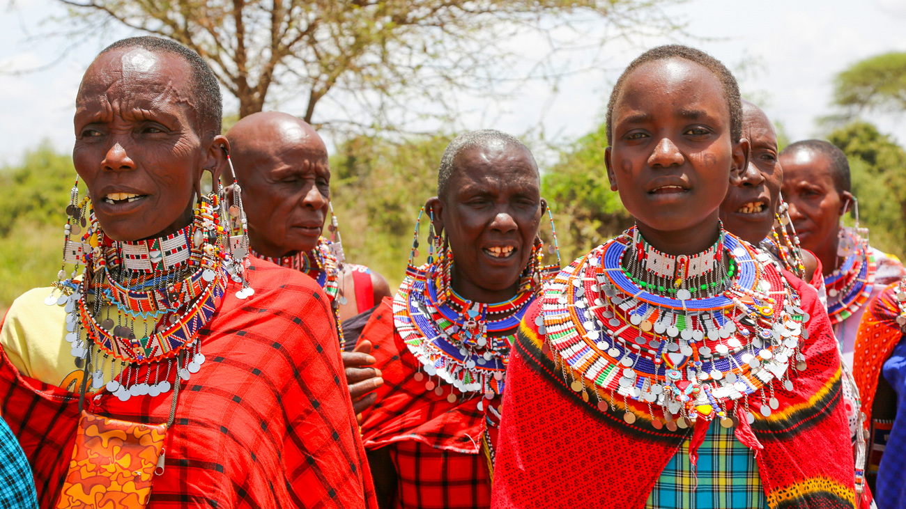 Two of the women from Esiteti village wearing layers of beaded necklaces and earrings during a Maasai ceremony.