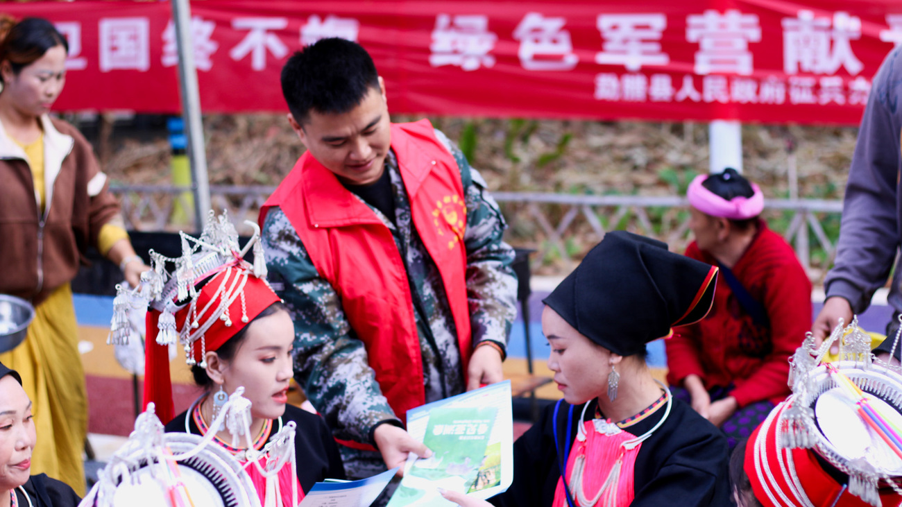 Ranger Li Jie shares information on human-elephant safety precautions with local community members in Mengla County, China.