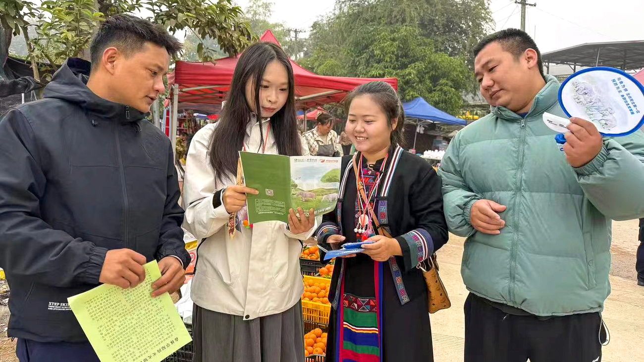 At the local town market, rangers Yan Wen and Cha Zhe are engaging with passersby—sharing key safety tips and distributing informational leaflets.