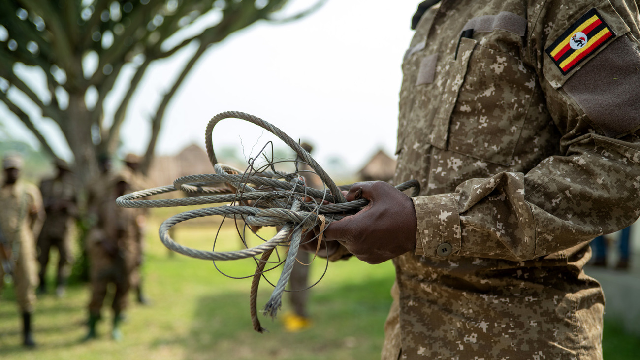 A warden in Queen Elizabeth National Park holds recovered wire snares often used to capture wildlife.
