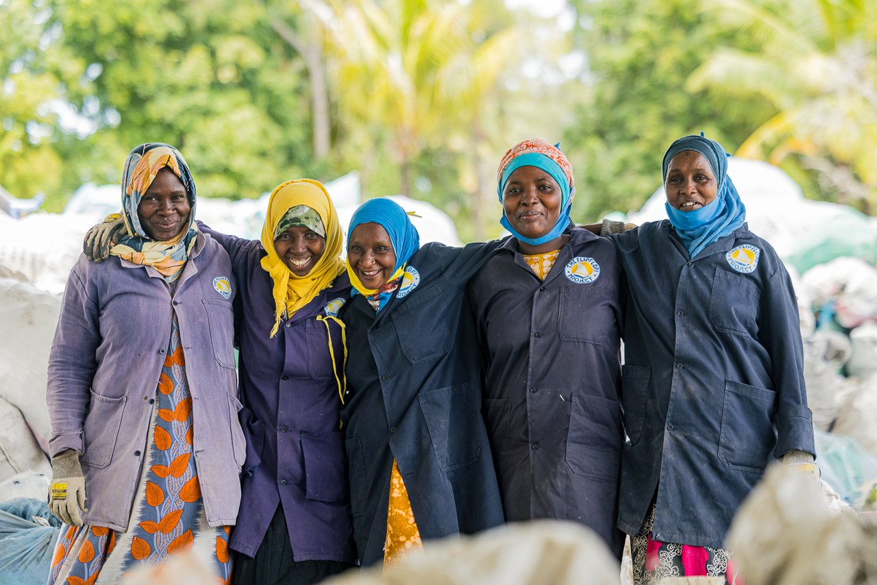Members of Flipflopi's collection and sorting team stand together at its material recovery facility in Lamu, Kenya.