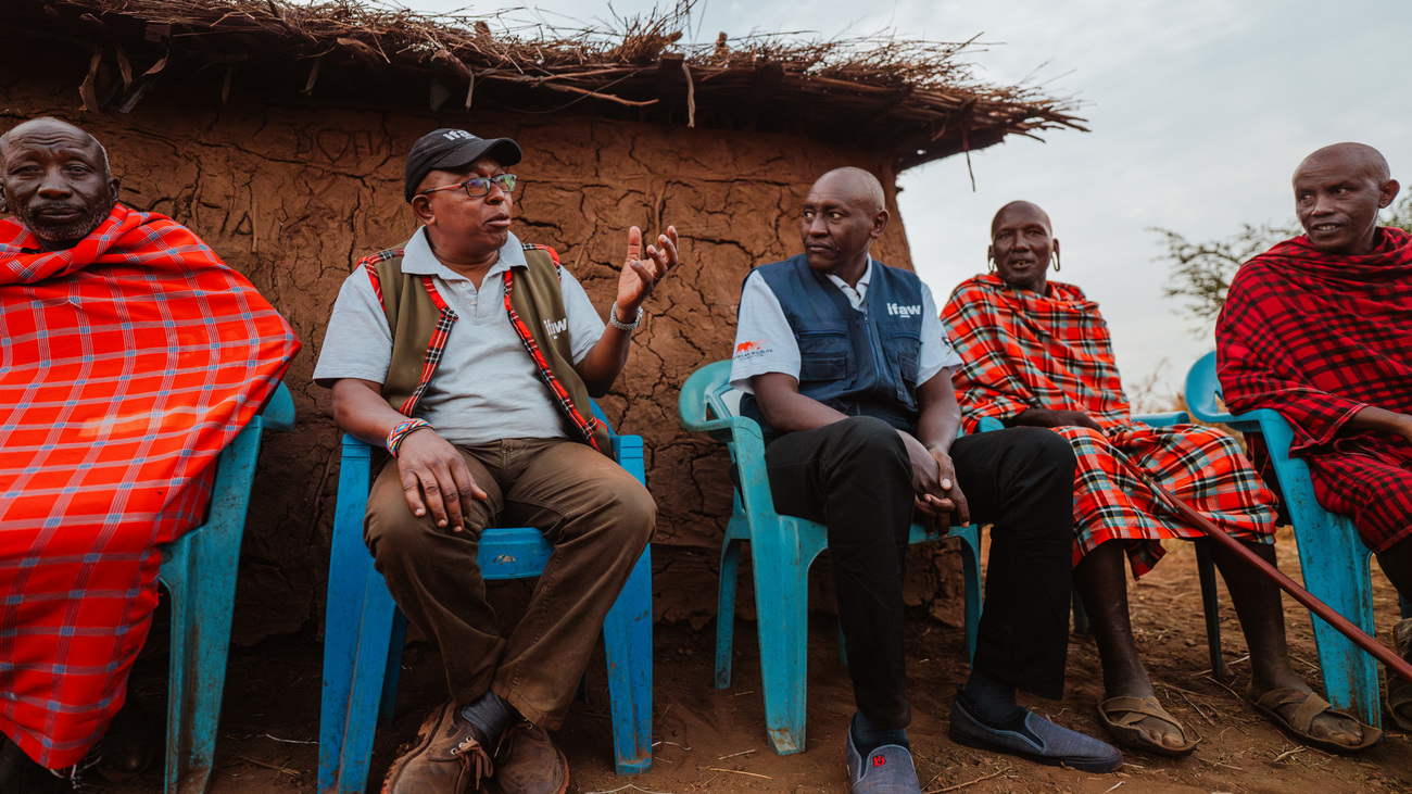 IFAW's Bernard Tulito (center) and Evan Mkala (second from left) engaging with the community in Kitenden Conservancy, Kenya.