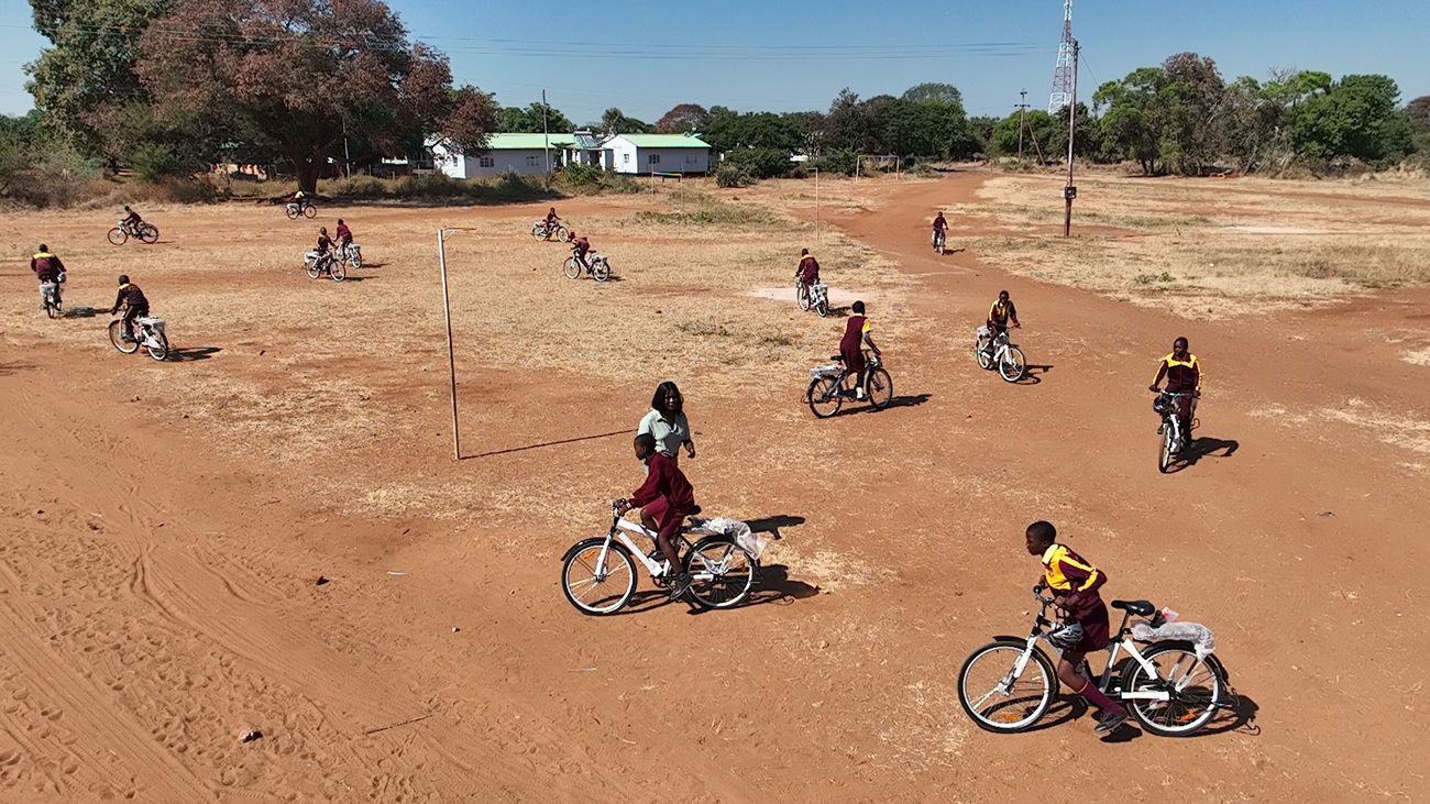Children ride bicycles provided through IFAW’s Room to Roam
